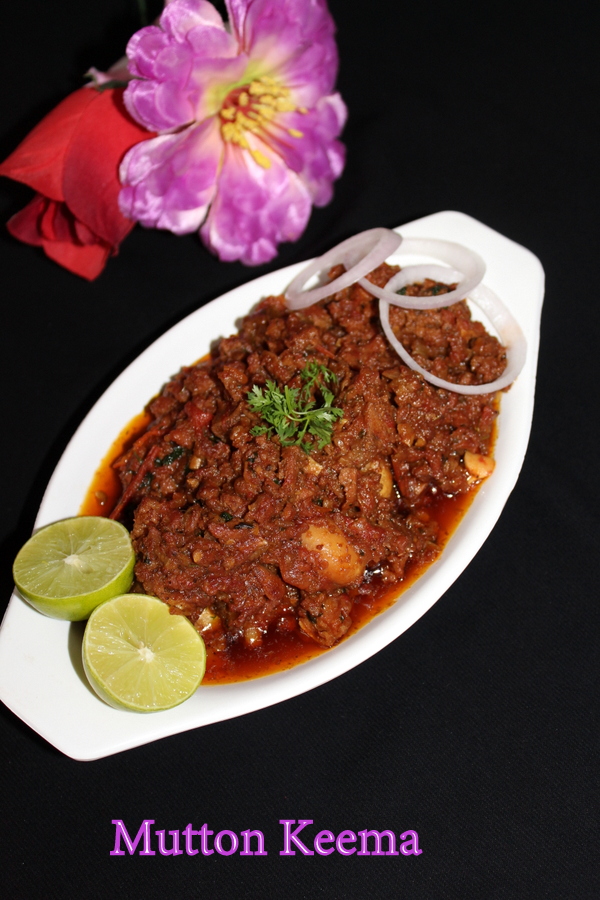 mutton keema in a bowl with garnished onion rings