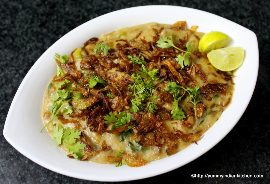 haleem served in a bowl with fried onions and cilantro leaves as topping