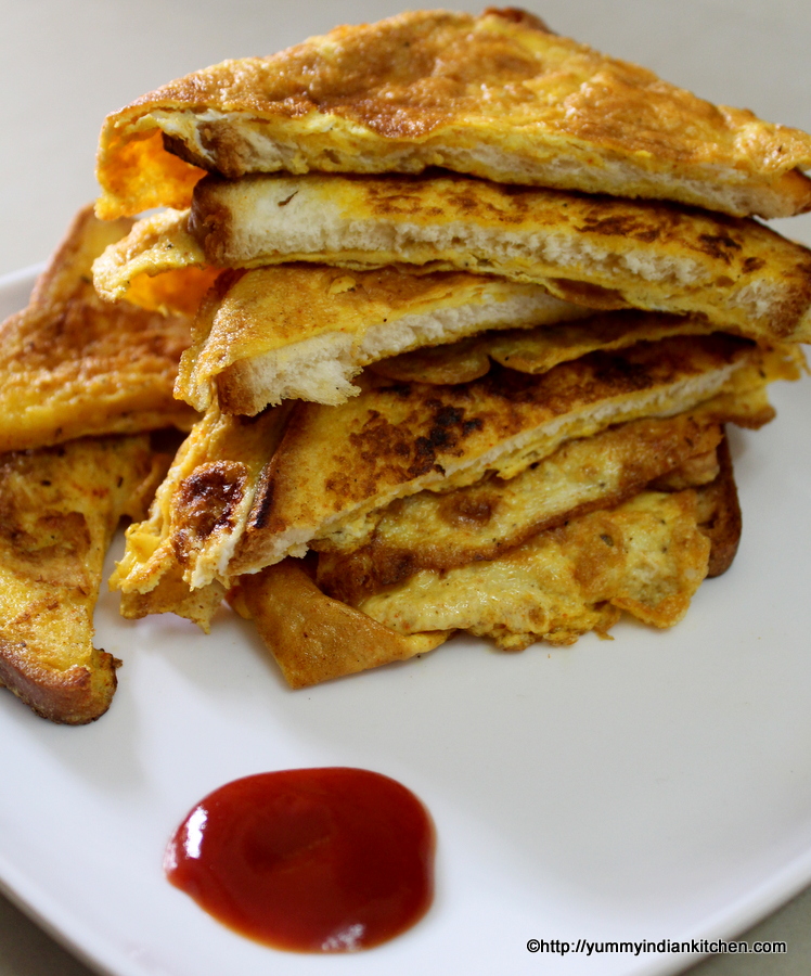 cooked bread omelette plated by slicing into two halves