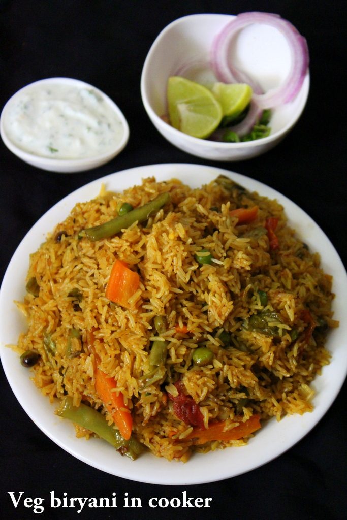 veg biryani in cooker or vegetable biryani in pressure cooker served in  a plate