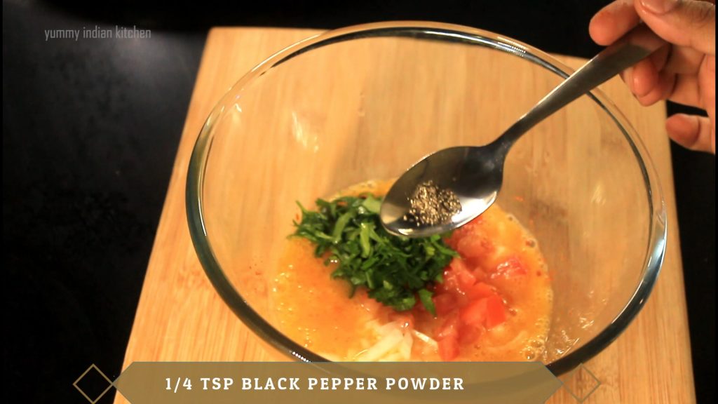 Adding chopped tomatoes, chopped coriander leaves, black pepper powder