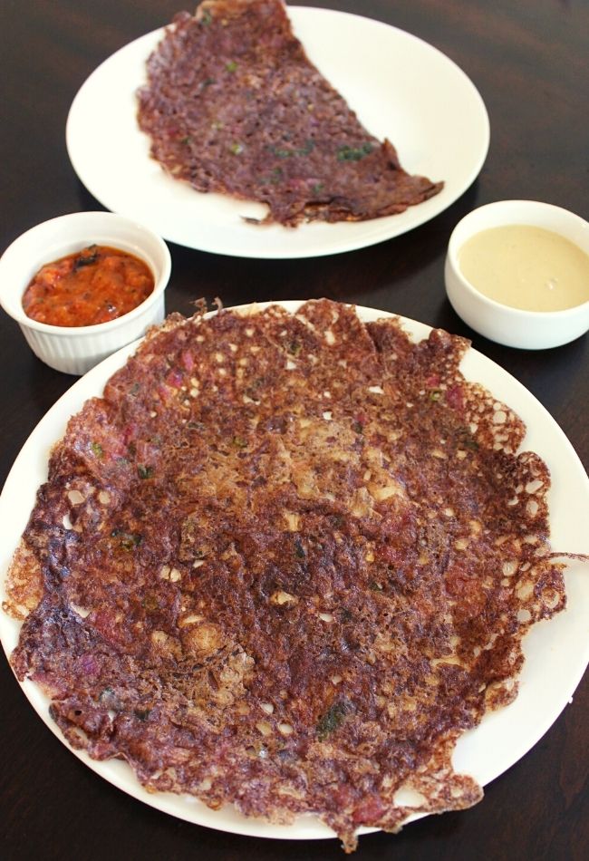 instant ragi dosa served on a plate with chutney in small bowls