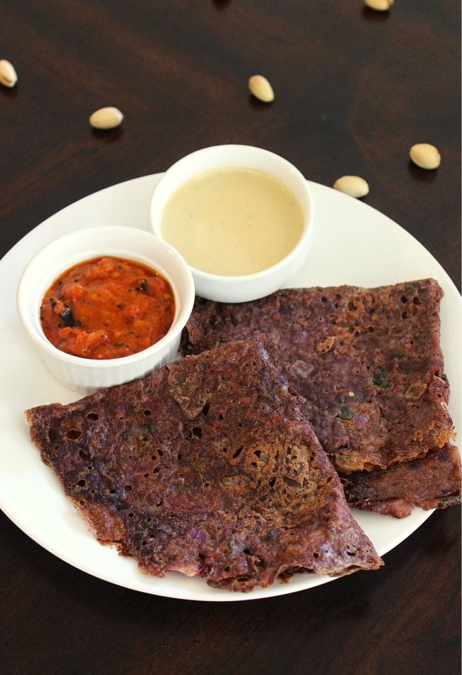 ragi dosa served on a plate with chutney in small bowls
