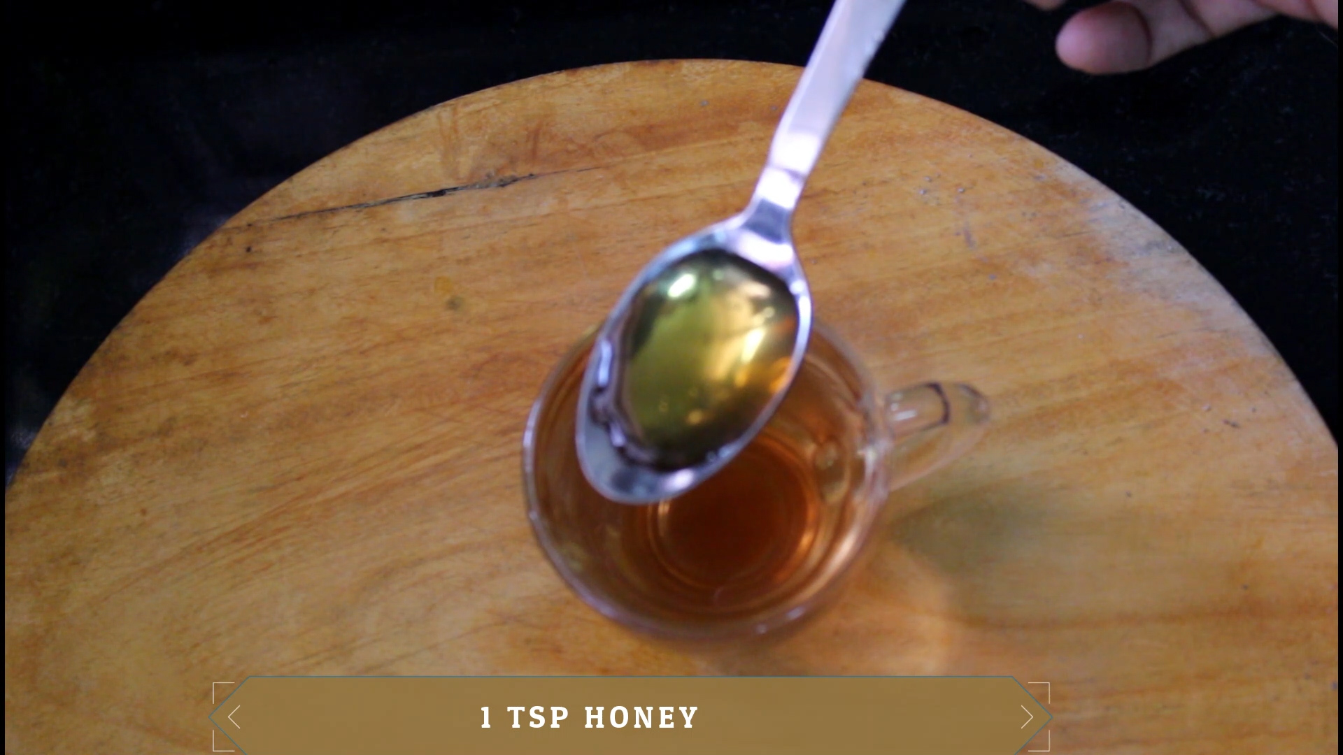 honey in a spoon to add into the drink