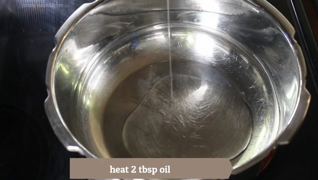 add oil to a cooker and heating it