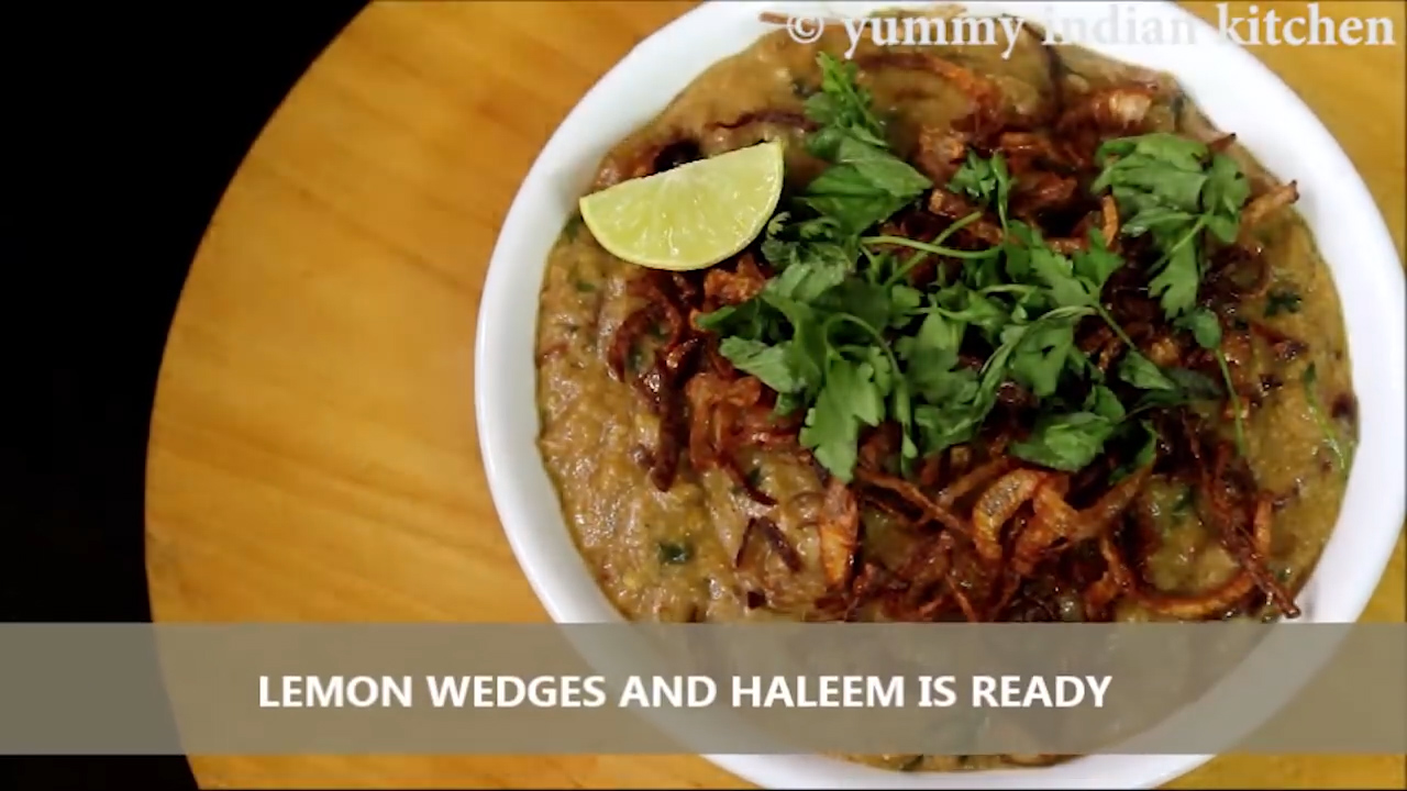 serving haleem with fried onions, lemon wedges and coriander leaves