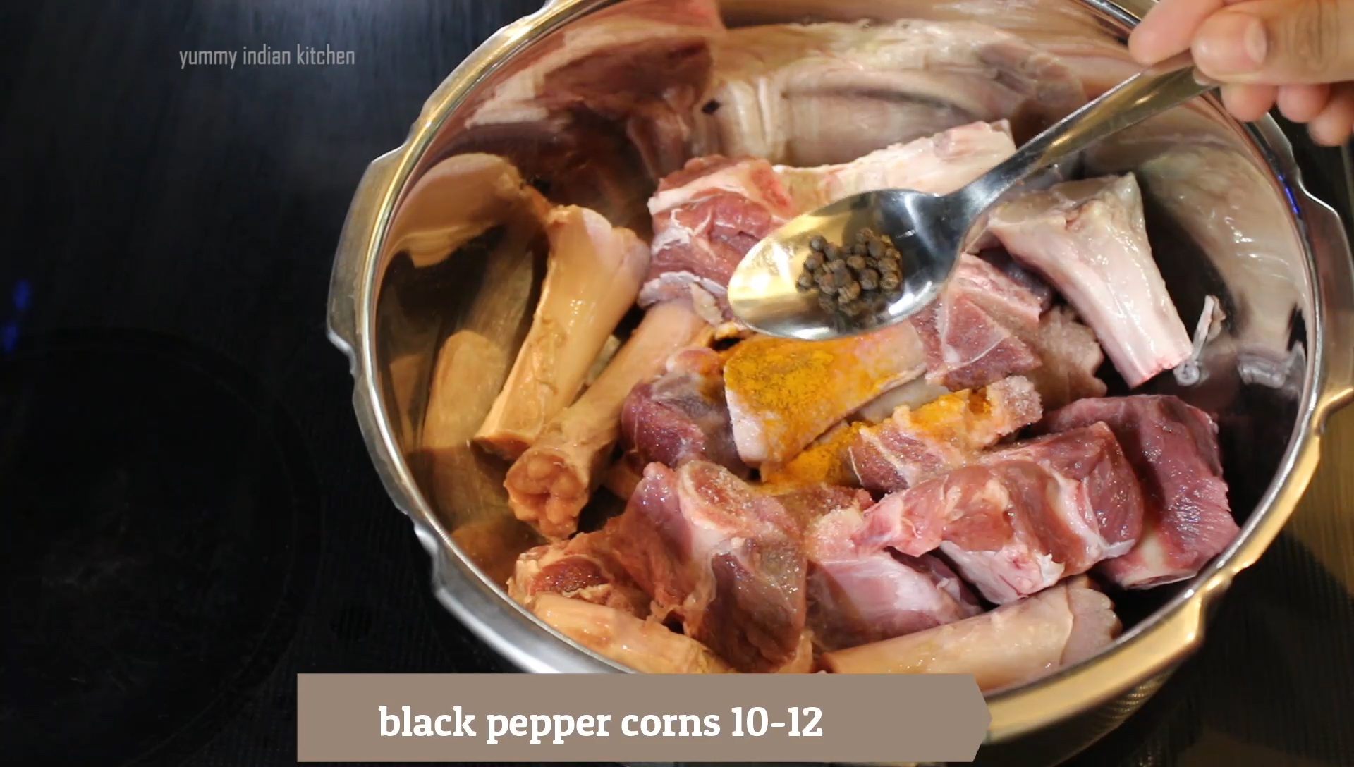 adding black pepper into the mutton