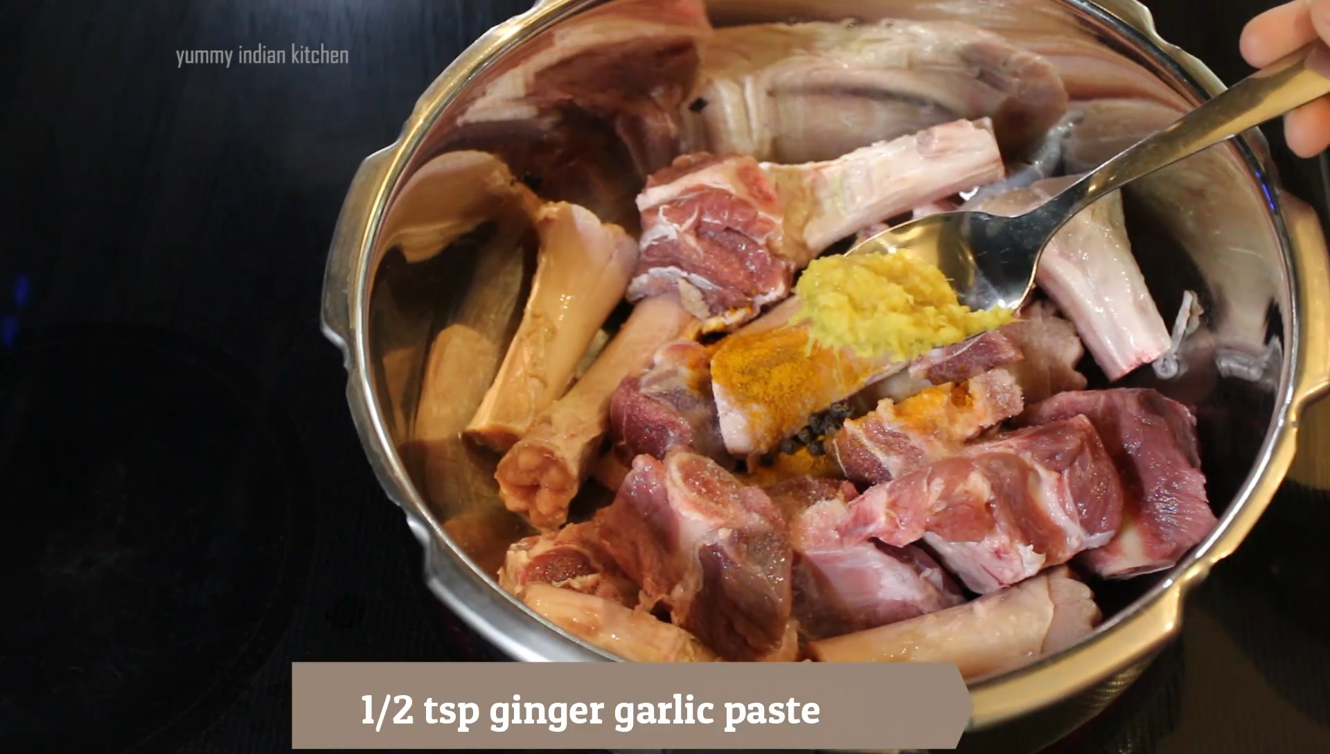 adding ginger garlic paste into the mutton