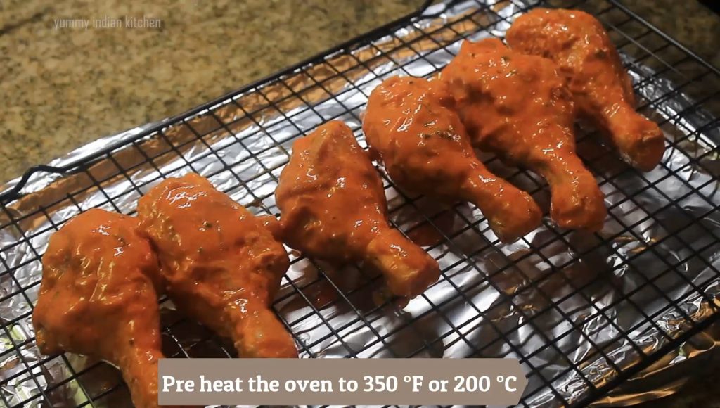 placing the marinated chicken legs on the baking grid