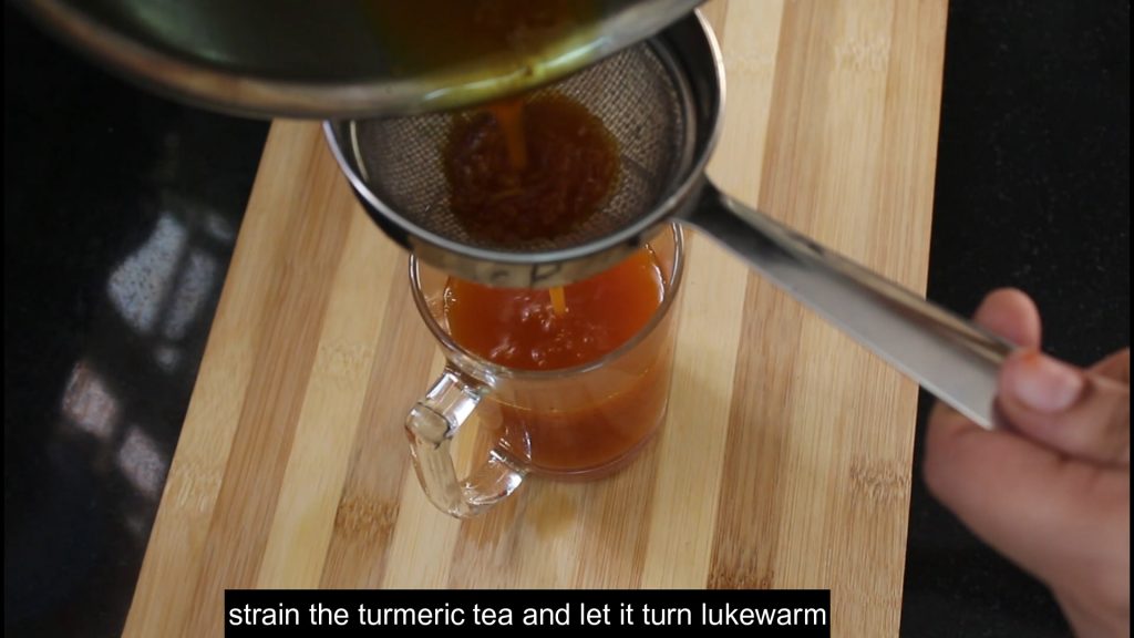 straining the drink into the glass