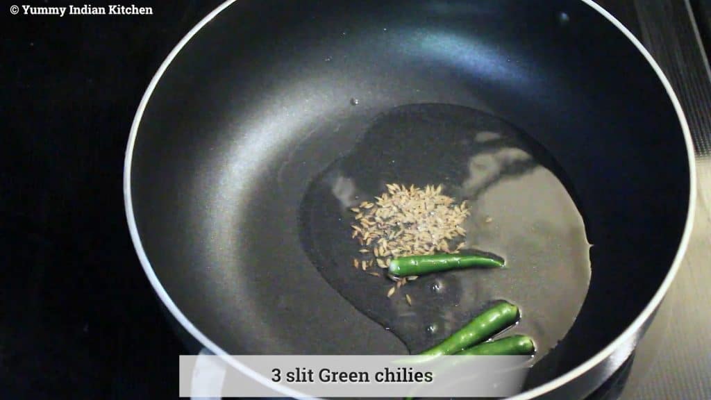 adding the cumin seeds, adding slit green chilies