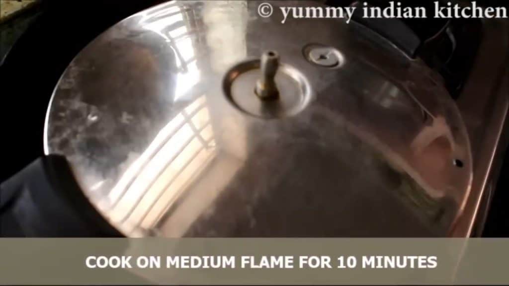 Cooking the pressure cooker cake on medium flame for 10 minutes