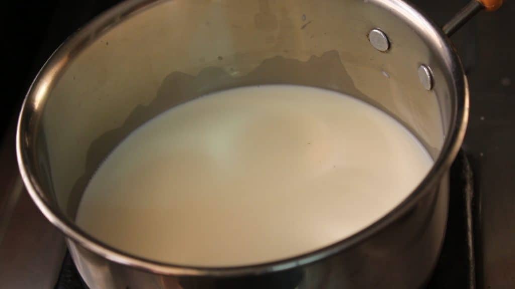 boiling the milk by turning on the heat