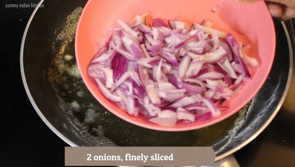 adding chopped onions into the pan