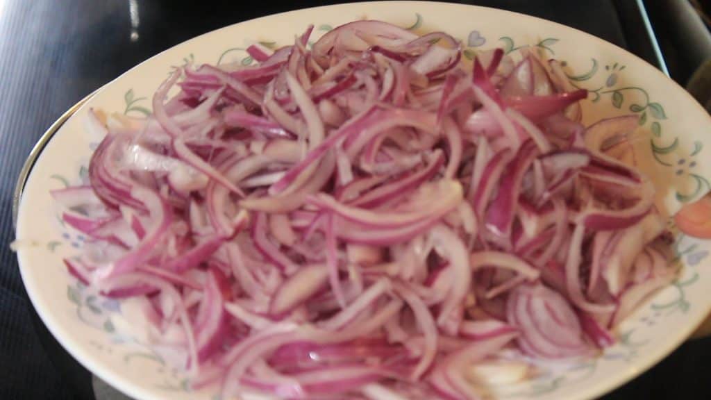 showing sliced onions to fry