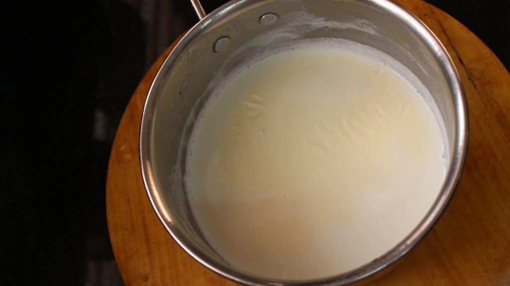 allowing the milk to turn slightly warm from hot