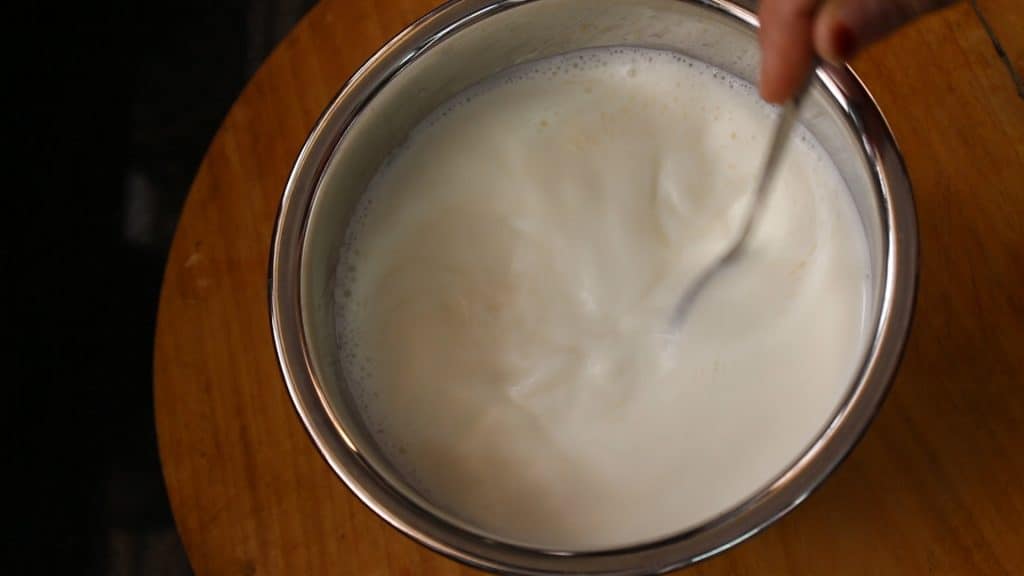 Stirring homemade curd well and give a good mix