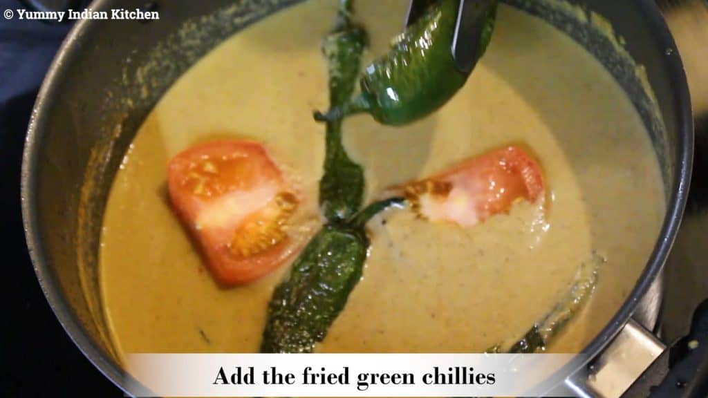 adding tomatoes and green chilies to make mirchi ka salan