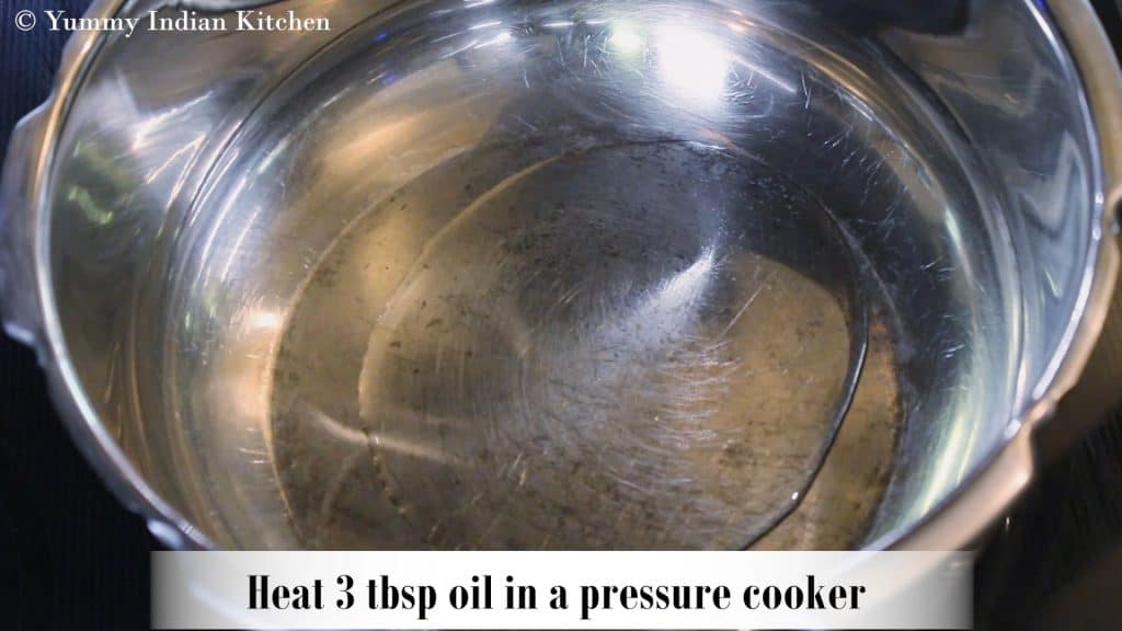  adding oil to a cooker and heating it.