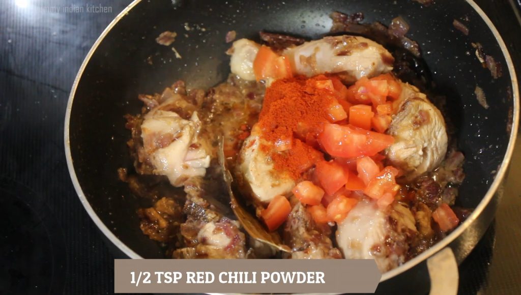Adding the chopped tomato and red chili powder