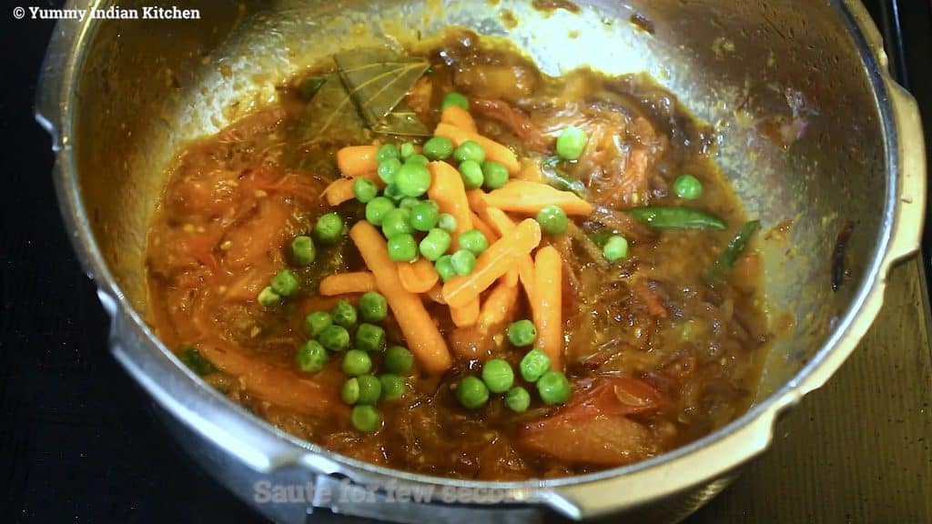 adding julienned carrots into it and adding green peas