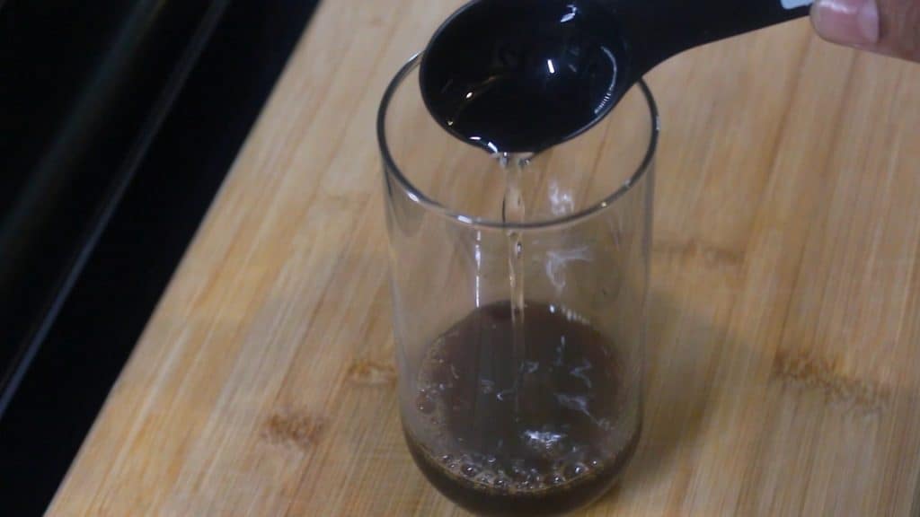 pouring vanilla syrup into the glass