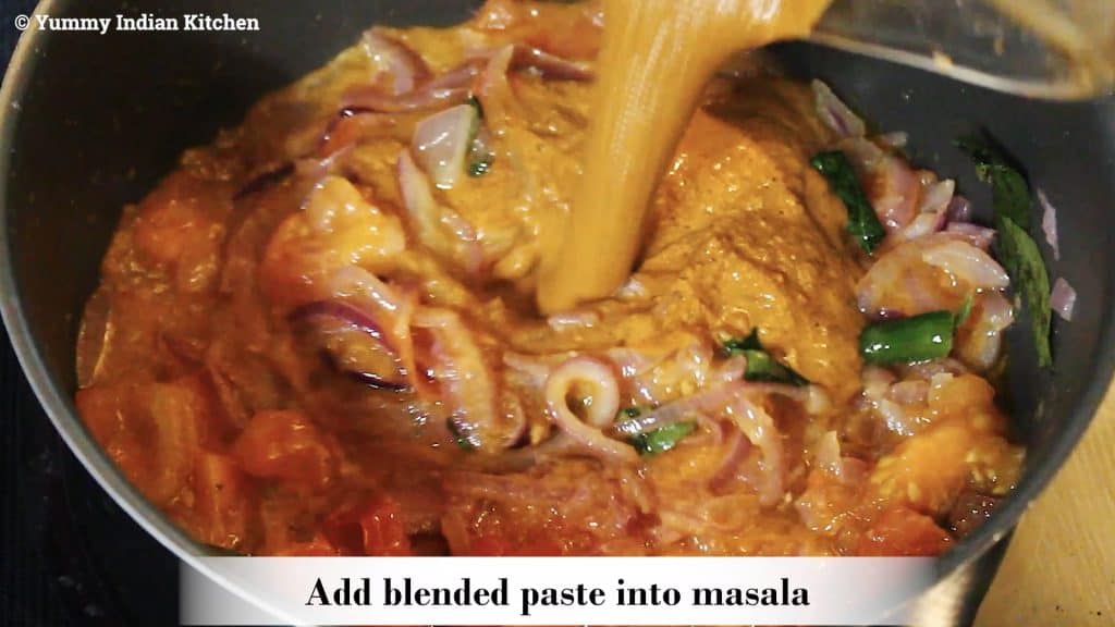 Adding the blended paste into the onion tomato masala of chettinad chicken curry