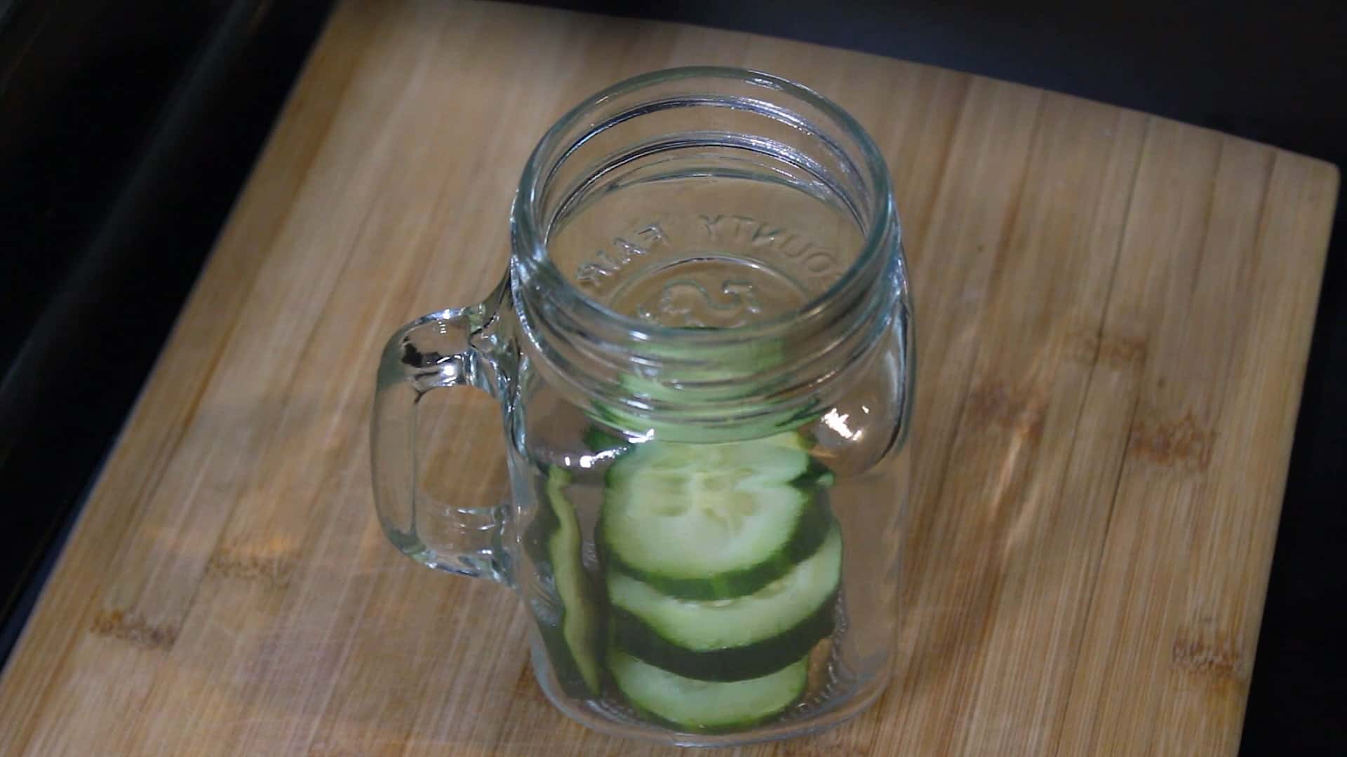 cucumber slices added in a jar