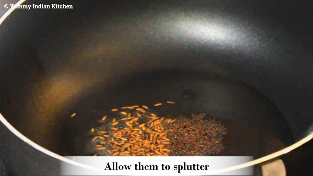 Adding mustard seeds, cumin seeds and allowing to splutter