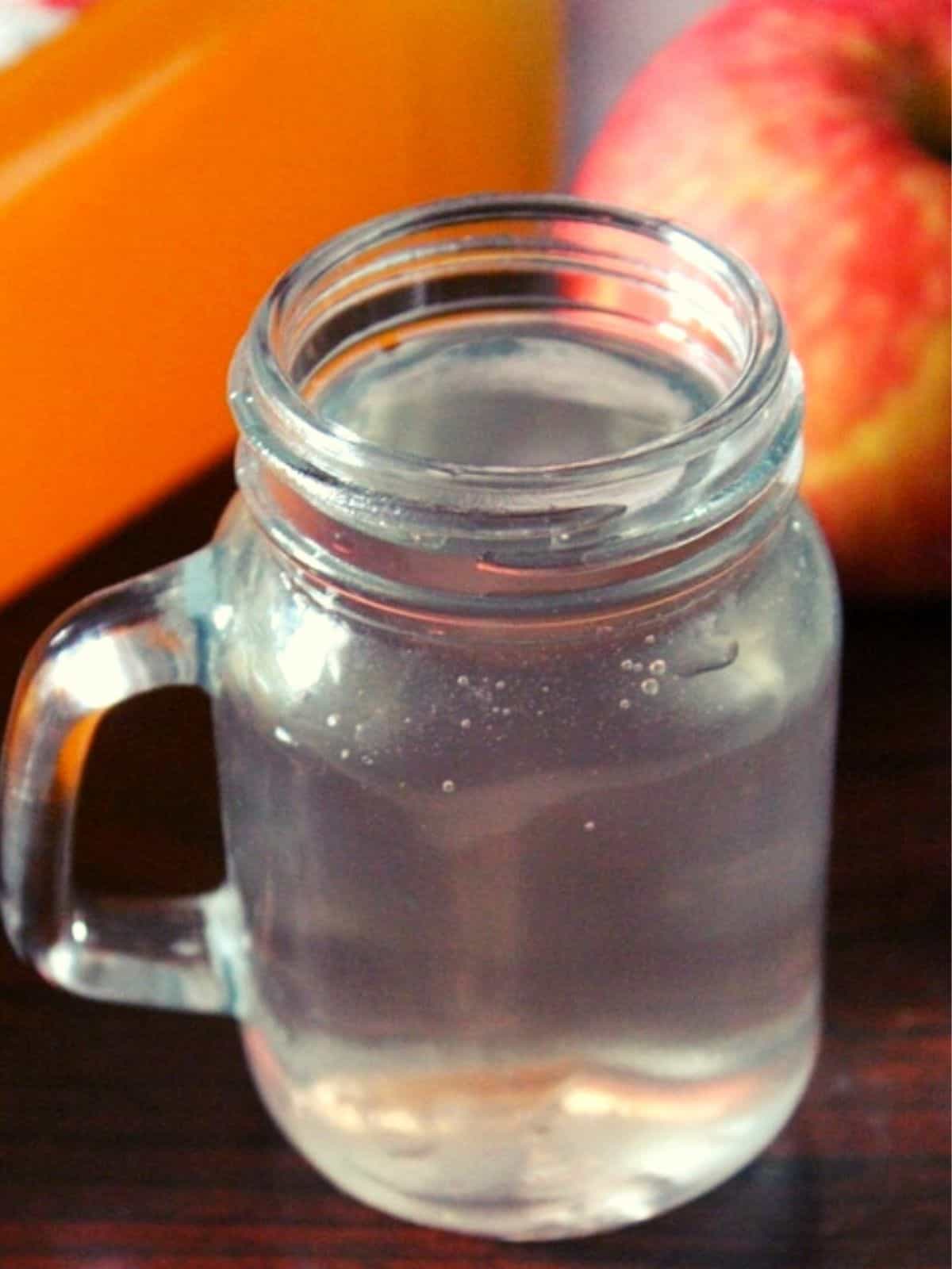 apple cider vinegar mixed in water and served in a glass jar