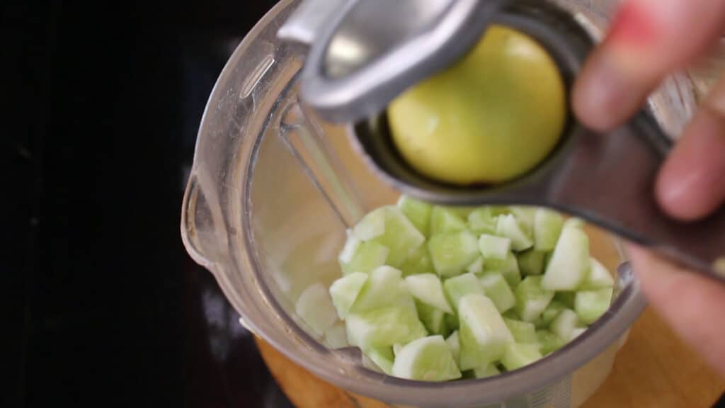 squeezing a few lemon drops into the jar 