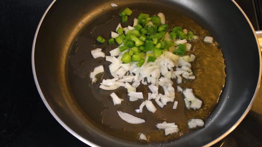  adding chopped onions, chopped green capsicum, chopped spring greens
