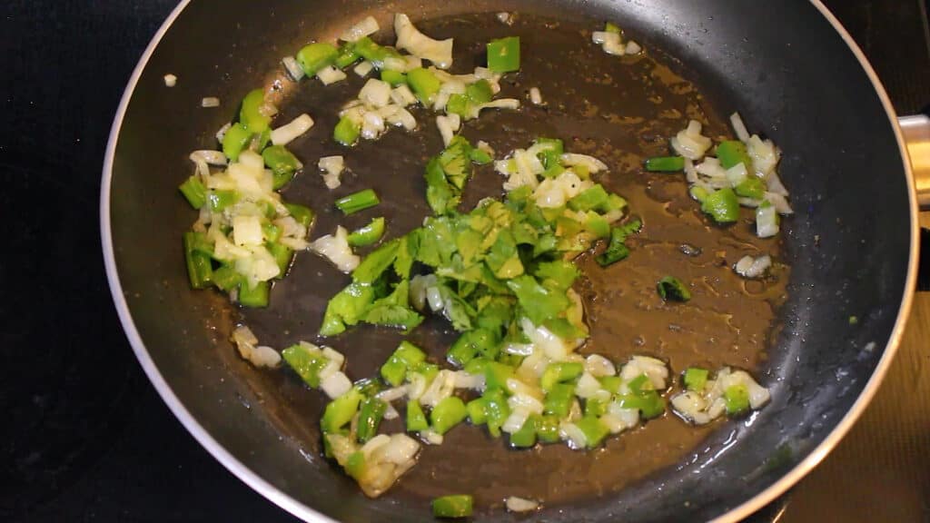  adding coriander leaves and stir frying