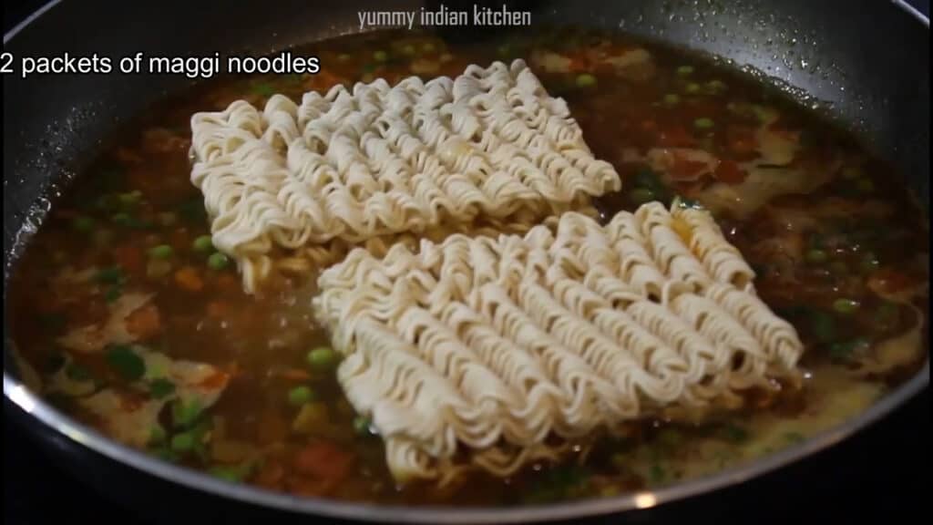 Adding the noodles from the Maggi packet into the water