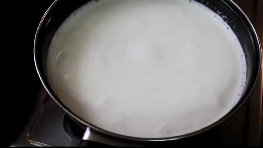 boiling the milk in a wok or a pan
