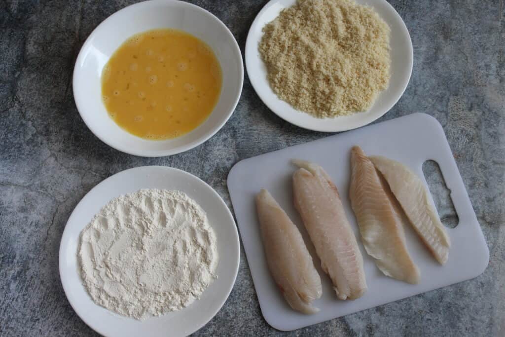 fresh tilapia pieces placed on a board