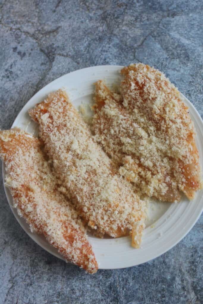 coating the fish fillets with flour, eggs, breadcrumbs and set them aside