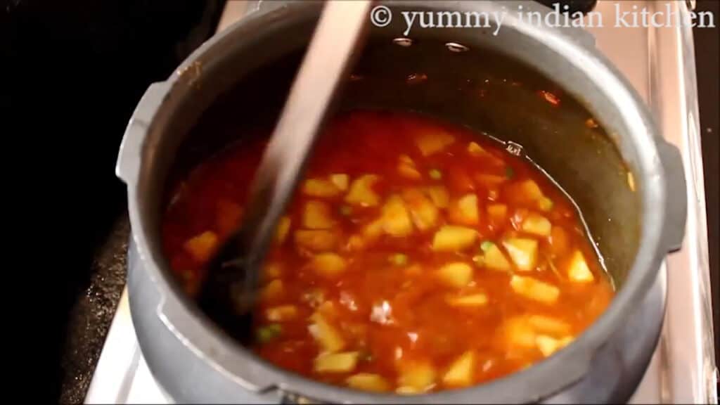 adding water to cook the aloo matar