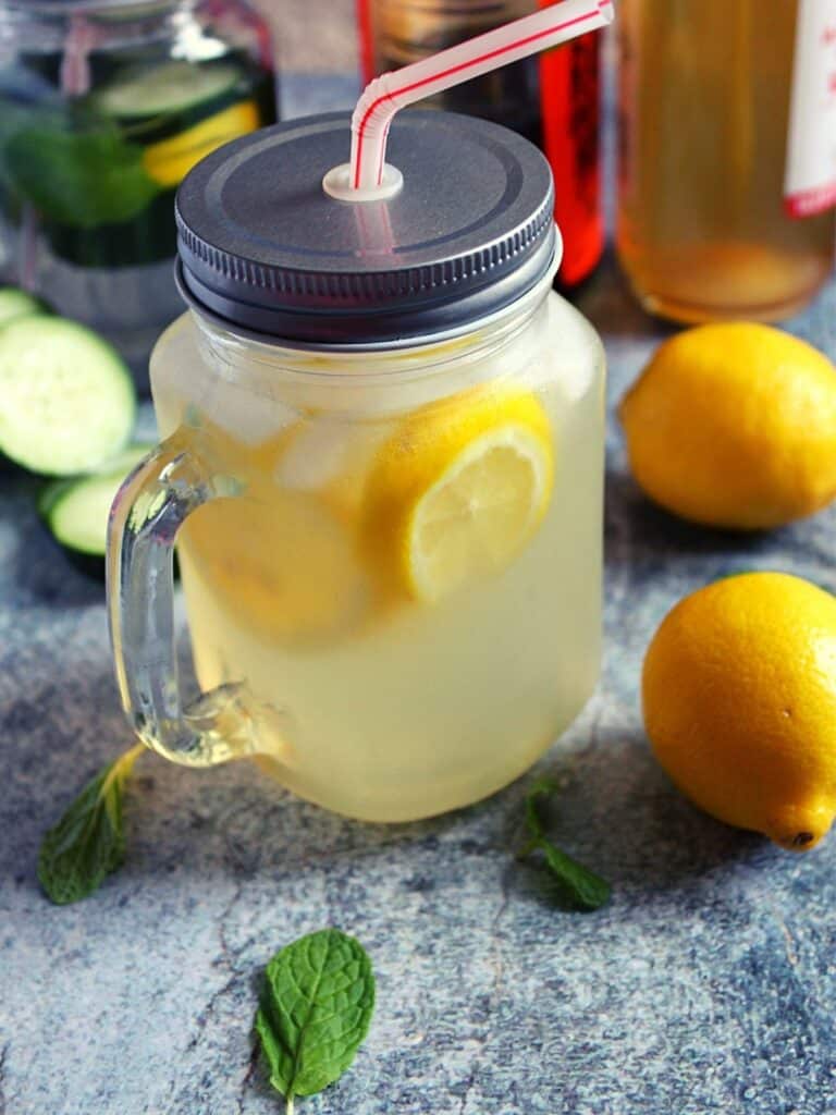 apple cider vinegar and lemon detox drink served in a mason jar