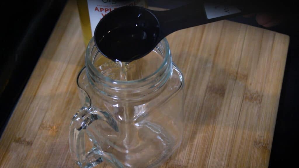 Adding a tablespoon of apple cider vinegar to the jar