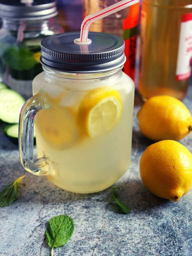 apple cider vinegar and lemon detox drink served in a mason jar
