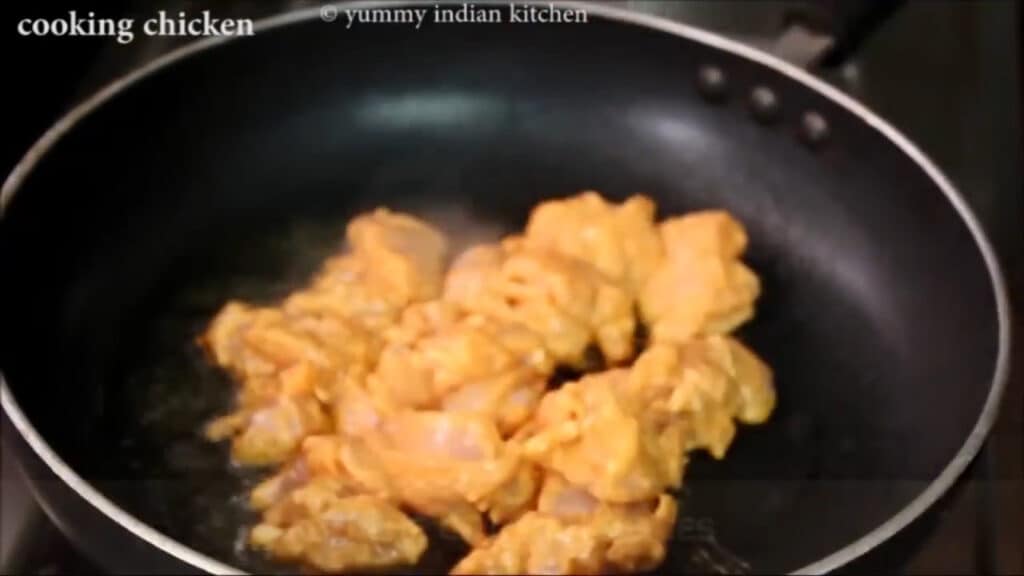 Adding the chicken pieces into the oil