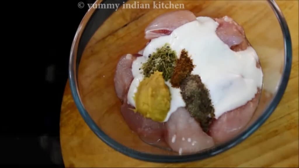 marinating the chicken with yogurt and dry spices