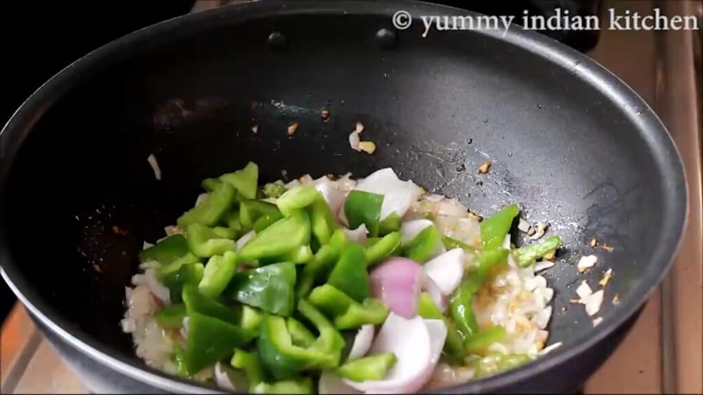 Add cubes of onion and green capsicum