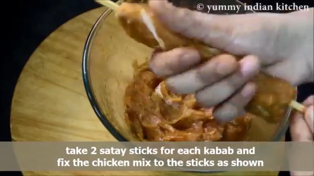 Applying the chicken dough to the sticks 