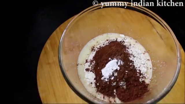 Adding maida, cocoa powder, baking powder, salt and mix well
