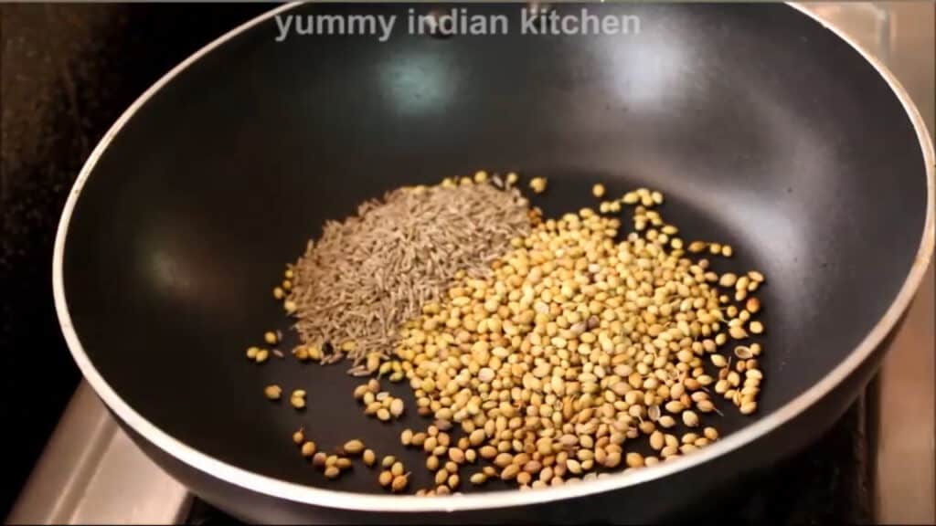 dry roasting coriander seeds and cumin seeds into a pan 