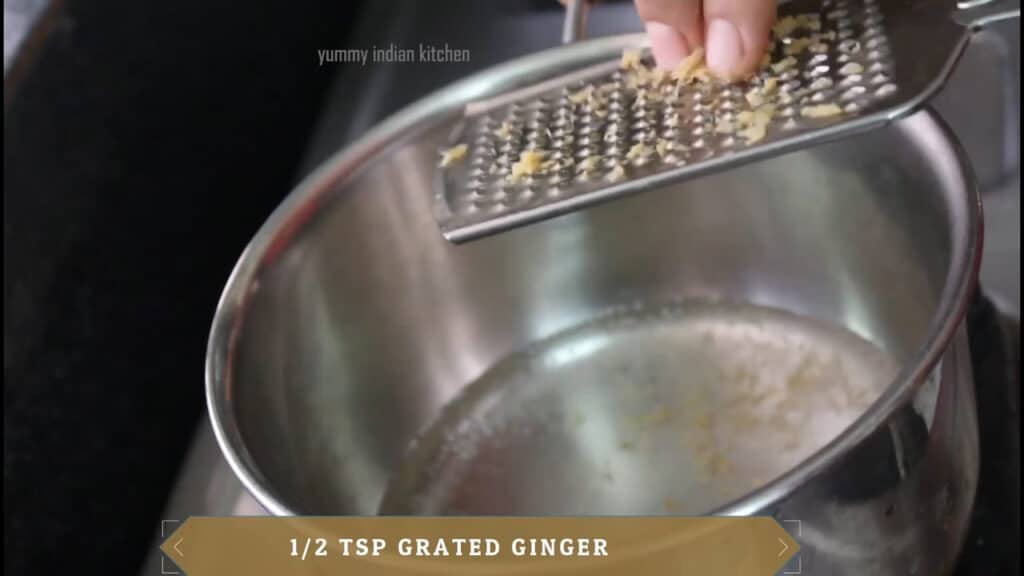 Grating around half a teaspoon of ginger into the water