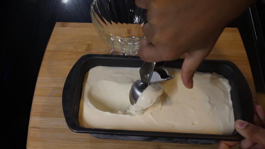 scooping out the homemade ice cream with condensed milk