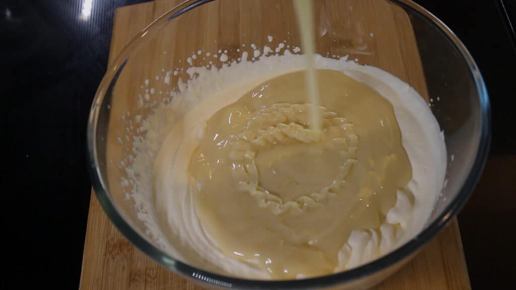 Adding sweet condensed milk to the bowl